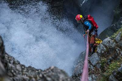A canyoner takes an abseil down into the depths of rushing water in a canyon in Wanaka, New Zealand.