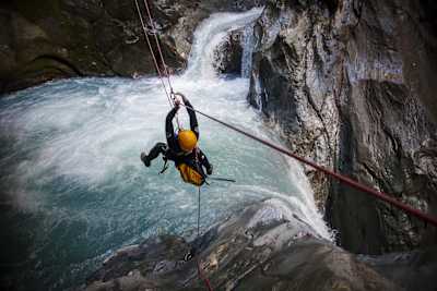 A participant uses ropes to travel across a canyon in Wanaka, New Zealand.