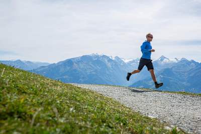 Lukas Pilz runs on gravel mountain track in Zell am See.