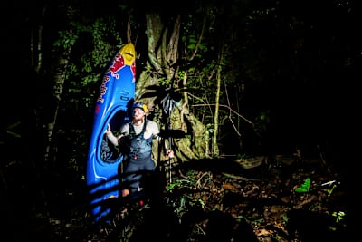 Adrian Mattern pictured with his kayak at night in the rainforest of Ivindo National Park, Gabon.
