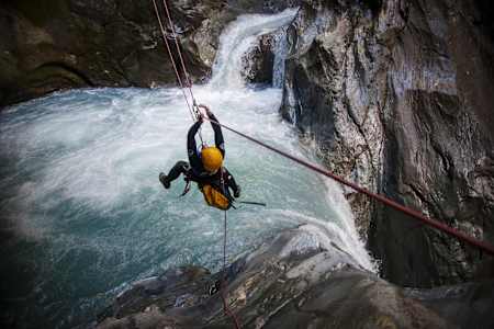 A participant uses ropes to travel across a canyon in Wanaka, New Zealand.