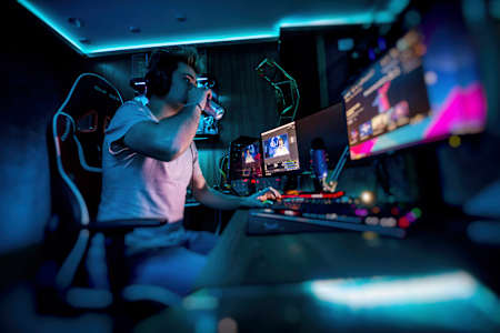 A gamer sips a can of Red Bull while streaming.