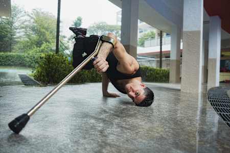 An action photo of B-Boy Lazylegz doing a freeze.