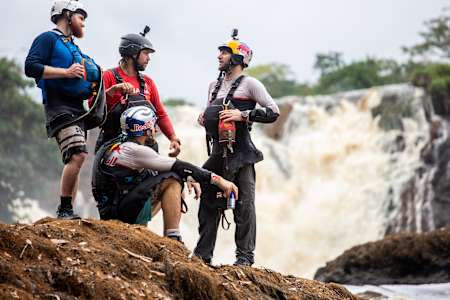 Kayakers Dane Jackson, Adrian Mattern, Bren Orton and Kalob Grady talking besides the Ivindo River in Gabon.