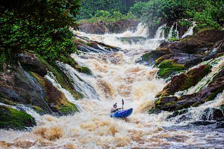 Kayaker Adrian Mattern descends a set of rapids on the Ivindo River in Gabon.