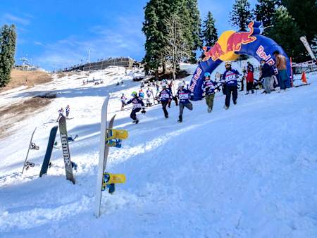 Participants running to pick their snowboards at Red Bull Homerun 