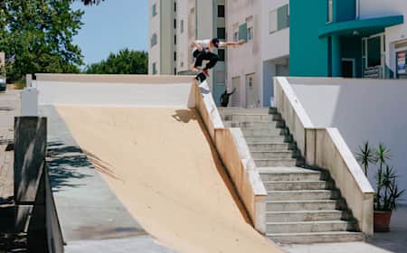 Alex Midler Kickflips a hubba into a bank in Portugal.