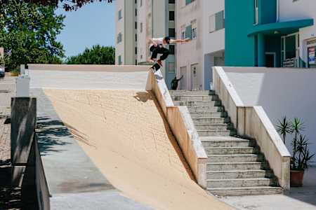 Alex Midler Kickflips a hubba into a bank in Portugal.