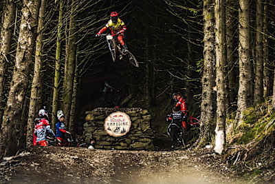 Participants watch on as rider hits a big drop at Red Bull Hardline