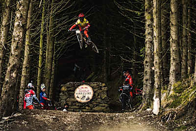 Participants watch on as rider hits a big drop at Red Bull Hardline