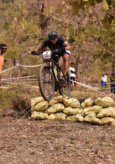 A participants rides over obstacles at the MTB National Championships in Pune, India.