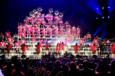 A photo of Beyoncé performing with a marching band at the 2018 Coachella Valley Music And Arts Festival.