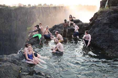 Tourists enjoy Devil's Pool at Victoria Falls in Zambia.
