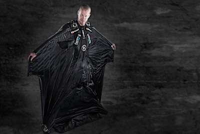 Jeb Corliss in an all-black wingsuit. 
