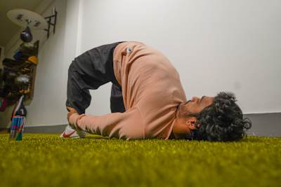 Fitness trainer Karan Bagri performs a Shaolin stretch in his home gym.