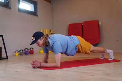 Triathlete Mika Noodt does a plank for a photo shoot to warm up for his strength training.