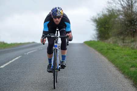 Gordon Benson rides down a road.