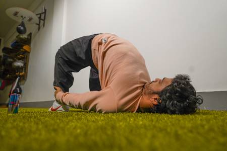 Fitness trainer Karan Bagri performs a Shaolin stretch in his home gym.