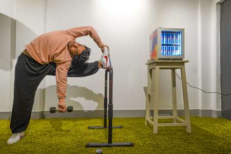 Fitness trainer Karan Bagri performs a Shaolin stretch in his home gym.