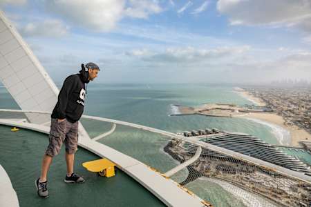 Łukasz Czepiela looks over the edge of the Burj Al Arab helipad in Dubai.
