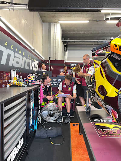 Tony Arbolino in the pit garage with his support team at the Dutch MotoGP Grand Prix in June 2023.