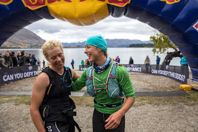 Competitors laugh at the finish line of an adventure race.