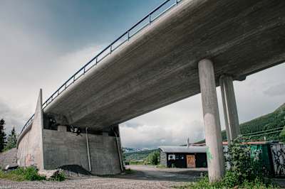 Martin Söderström performs some slopestyle tricks underneath a bridge in Åre Bikepark in Sweden.