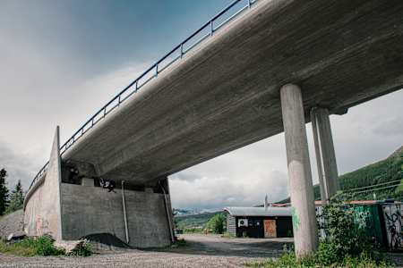Martin Söderström performs some slopestyle tricks underneath a bridge in Åre Bikepark in Sweden.