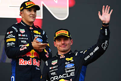  Max Verstappen celebrates on the podium alongside team-mate Isack Hadjar following the 2026 F1 Grand Prix of Azerbaijan at Baku City Circuit.