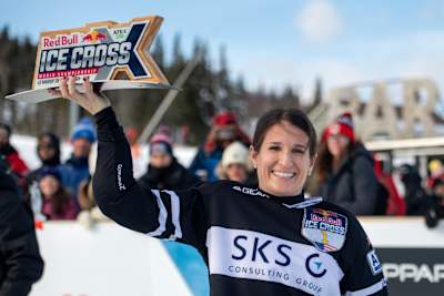 Amanda Trunzo holds aloft her trophy after winning the women's race at the Red Bull Ice Cross World Championship stop in Le Massif de Charlevoix, Canada on February 22, 2020.