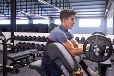 Marc Marquez is pictured doing bicep curls at the gym in Cervera, Spain.