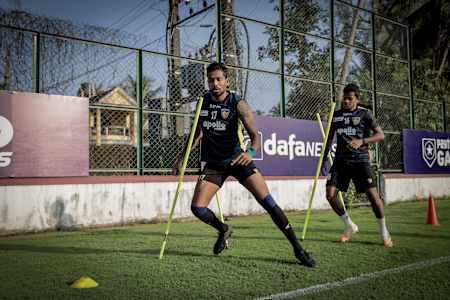 Dhanpal Ganesh of Chennaiyin Football Club runs through slalom poles during a training session.