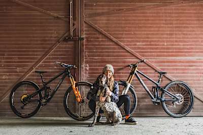 Rachel Atherton with her dog and two Atherton Racing team bikes in Wales in 2021.