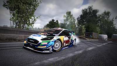 A screenshot of a Red Bull vehicle against a backdrop of trees in WRC 10.