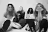A black-and-white group photo of The Aces.