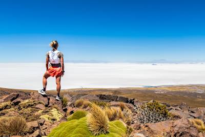 Fernanda Maciel stands on rocks and looks back over the Salar de Uyuni, Bolivia in September 2026.