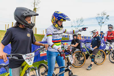 Payton Ridenour and Khothalang Leuta stand at the Lisbon track.