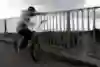 Bas Keep looks over a bridge onto car traffic during his More Walls bike project.