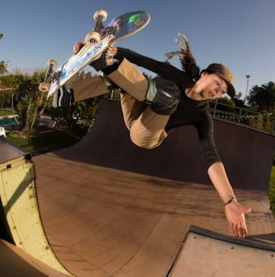 Lizzie Armanto clears the channel to frontside invert on a vert ramp in California.