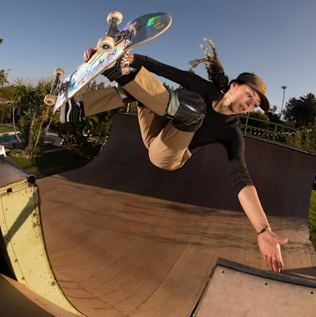 Lizzie Armanto clears the channel to frontside invert on a vert ramp in California.