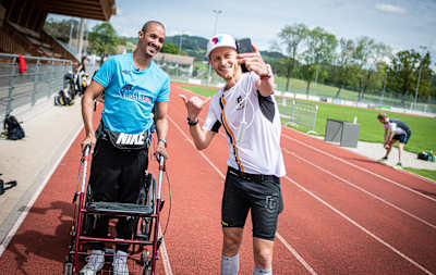 Local male winner Niklas Sjöblom of Sweden takes a selfie with David Mzee of Switzerland during the seventh edition of the Wings for Life World Run - App Run in Wetzikon, Switzerland on May 3, 2020.