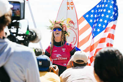 Caroline Marks gets chaired up the beach after winning the surfing world title