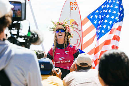 Caroline Marks gets chaired up the beach after winning the surfing world title