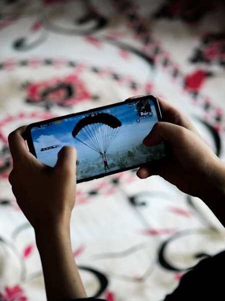 A gamer plays PUBG Mobile on a realme phone.