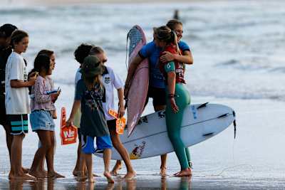 Stephanie Gilmore and Sierra Kerr share a moment on the beach at Snapper Rocks