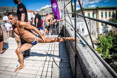 Constantin Popovici of Romania prepares to dive from Stari Most (Old Bridge) during the Red Bull Cliff Diving World Series in Mostar, Bosnia and Herzegovina on August 26, 2021. 