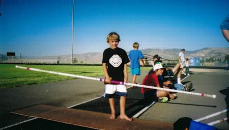 An image of a young Armand Duplantis holding a pole.