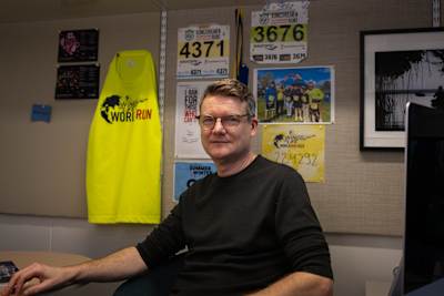 Christian Göritz posing infront of his Wings for Life World Run Wall at Karolinska Institutet in Stocholm Sweden where they conduct spinal cord injury research funded by the Wings For Life Foundation