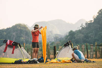 Rebecca Rusch and Huyen Nguyen set up tents along the Ho Chi Minh Trail in March, 2015.