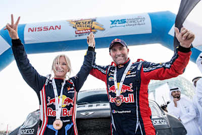 A photo of Stéphane Peterhansel and Andrea Peterhansel celebrating winning the 2019 Abu Dhabi Desert Challenge.